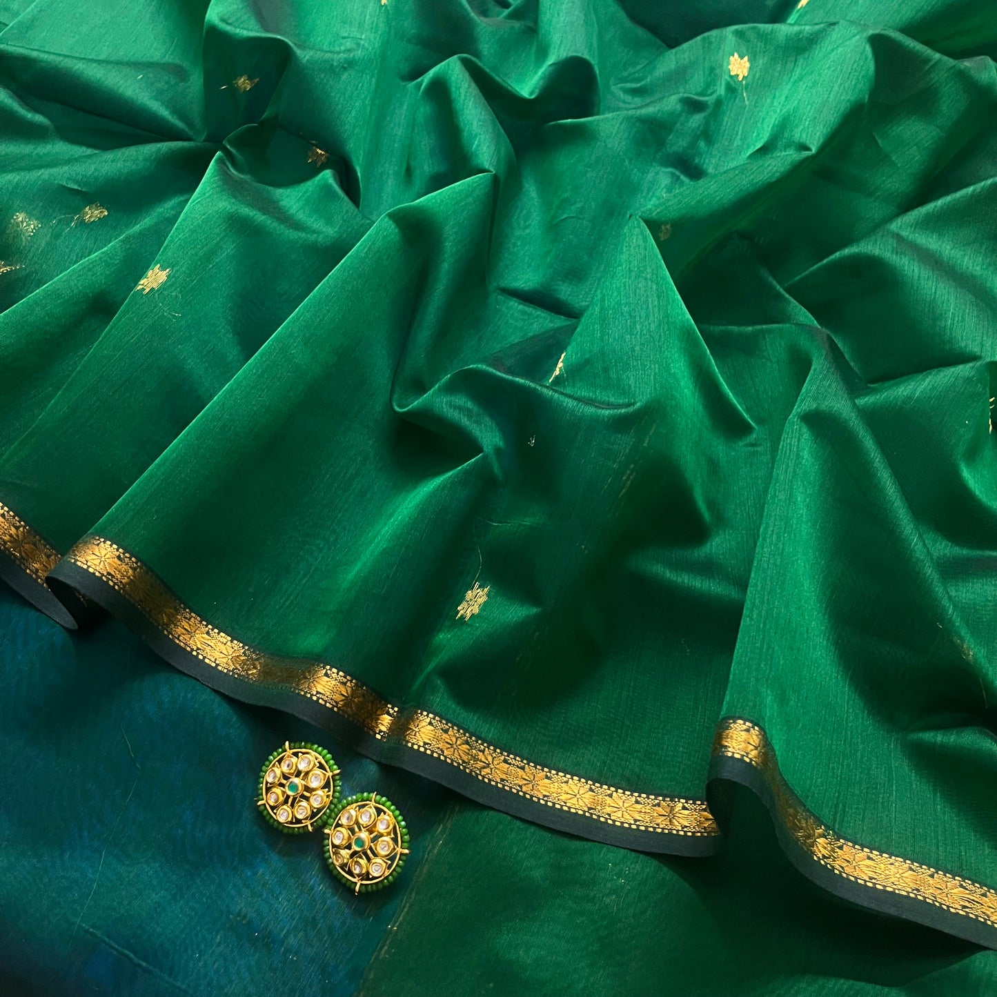 Green and blue maheshwari saree with flower bootis all over